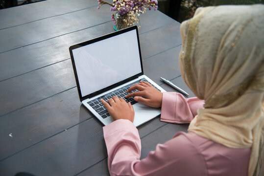 Muslim women working. Muslim woman wear hijab work from home office typing laptop keyboard on wooden desk office supply happy smiling face. Muslim woman wear hijab work from home office typing