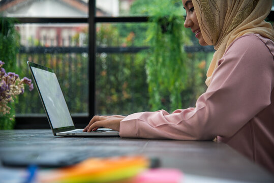 Muslim women working. Young Asian arabian muslim women working summary report business graph chart. Crop arabian muslim women working business report graph chart. Portrait woman wear hijab smile