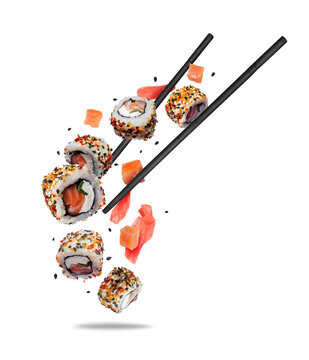 Floating sushi rolls with salmon and fresh pickled ginger in the air on a transparent background
