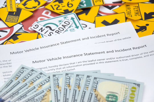 Car insurance policy document and toy cars on desk. Concept of insurance policy and car accident