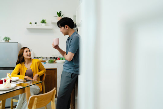 Asian couple enjoy eating together in kitchen room