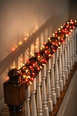 Fototapeta premium A decorative railing with Christmas lights on