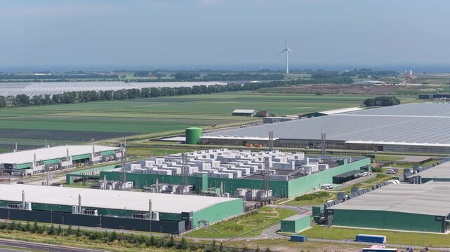 Aerial drone view of modern data center building, technology infrastructure with servers, cloud network and digital storage facility, industrial complex from above.