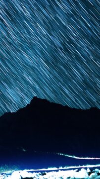 Vertical Shot of Star Trails Falling Down on Mt Whitney Peaks Astrophotography Night Sky Time Lapse in California USA