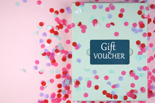 Gift voucher in a green envelope on a light background