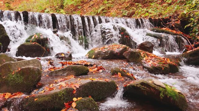 Large boulders overgrown with moss at waterfall