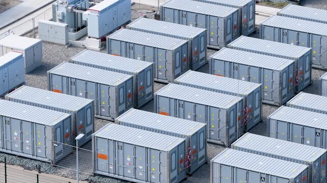 Aerial view on battery energy storage system for renewable power plant. Industrial lithium batteries facility for clean electricity grid management and sustainable technology infrastructure.