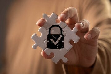 Cybersecurity and data protection concept featuring a secure lock within connected puzzle pieces, symbolizing privacy, compliance, risk management, information security, trust, and system integrity. © Bordinthorn