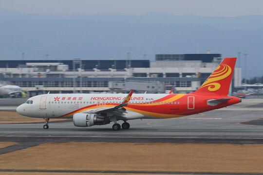 Hong Kong Airlines Airbus A320 taxiing in its red livery on January 11, 2016 in Aso Kumamoto Airport, Japan.
