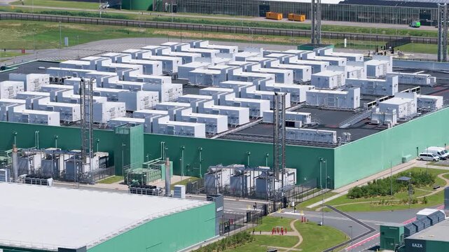 Aerial drone view of modern data center building, technology infrastructure with servers, cloud network and digital storage facility, industrial complex from above.