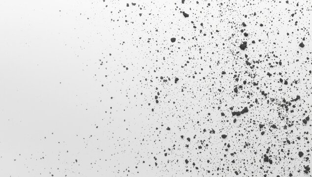 White matte background sprinkled with black charcoal dust texture and copy space