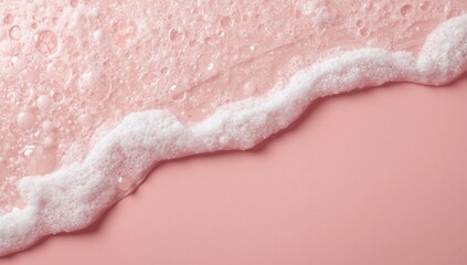 Fototapeta premium Shaving foam and shampoo bubbles forming a foamy texture on a pastel pink backdrop surface