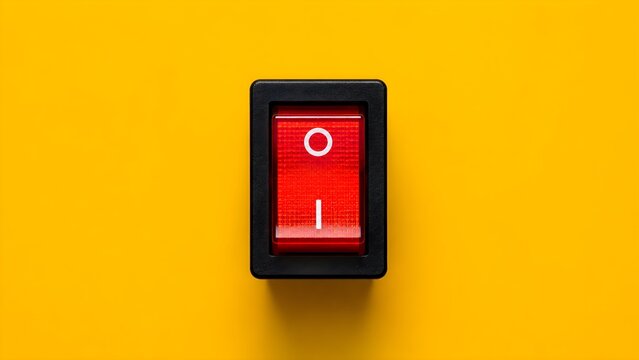 Red power switch on yellow background symbolizing control energy activation technology and industrial safety concepts