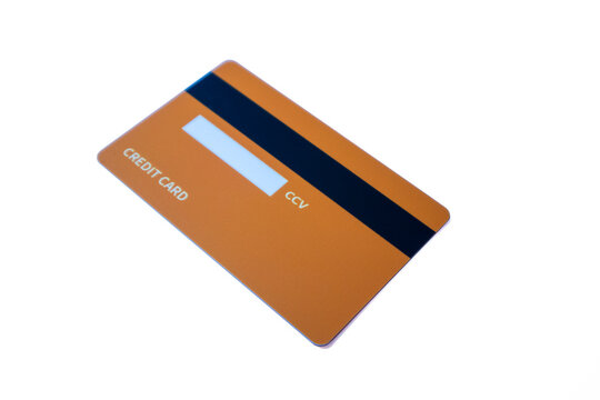 Angled back view of an orange credit card with magnetic stripe and CCV panel