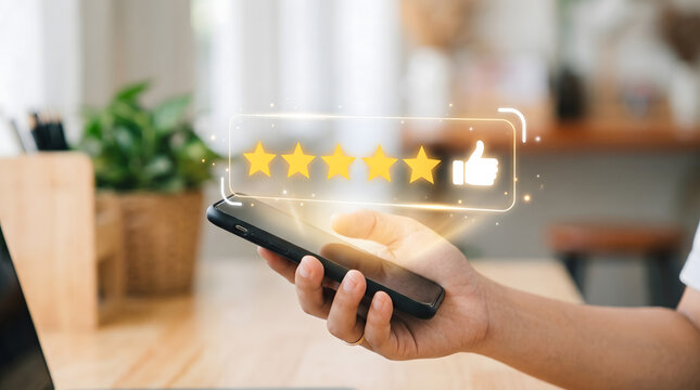 Close-up Hand Holding Smartphone Displaying Holographic Five Stars Review and Like Icon in Home Office