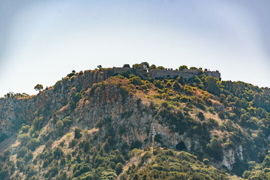 Ruined walls of Palaiokastro, medieval Old Navarino Castle above Voidokilia, with Cave of Nestor below, Pylos, Messenia, Greece