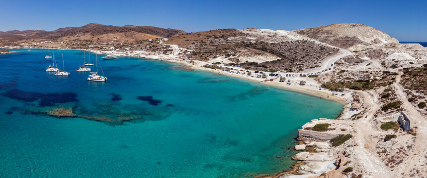 Panoramic aerial view of Prassa beach with turquoise waters and boats, Kimolos island, Greece