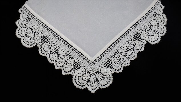 Lace Tablecloth Corner with Intricate Design on a Dark Background