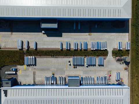 Aerial View of Modern Factories and Distribution Warehouses with HGVs in UK