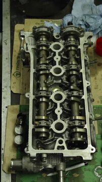 Mechanic holding a feeler gauge set to measure engine clearances.