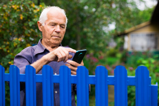 Senior man using smartphone outdoors