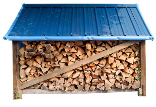 A neatly stacked pile of split firewood is stored beneath a simple wooden shelter with a blue metal roof. Isolated.