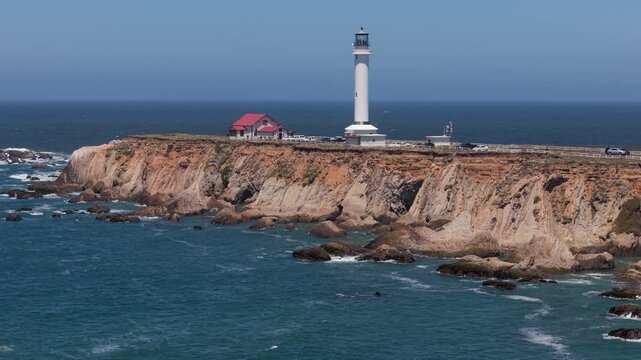 View of Point Arena Lighthouse on the northern California coast. The cliffs and ocean surround this landmark.