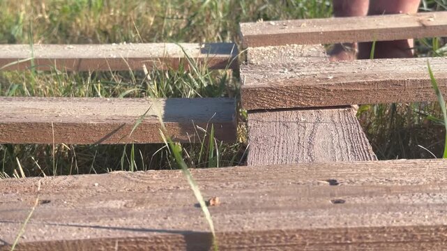 cutting a wooden pallet with a chainsaw, closeup . High quality 4k footage