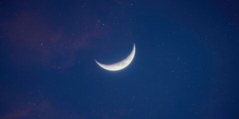 Fototapeta na wymiar Crescent moon glowing in a starry night sky