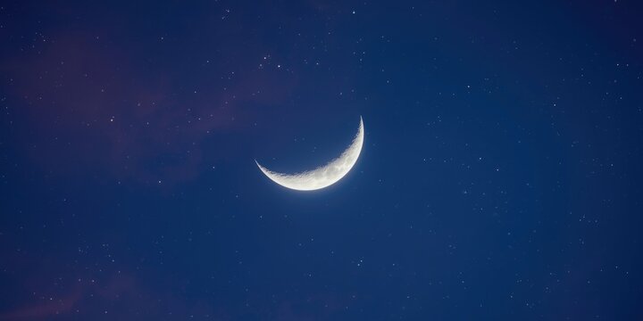 Crescent moon glowing in a starry night sky
