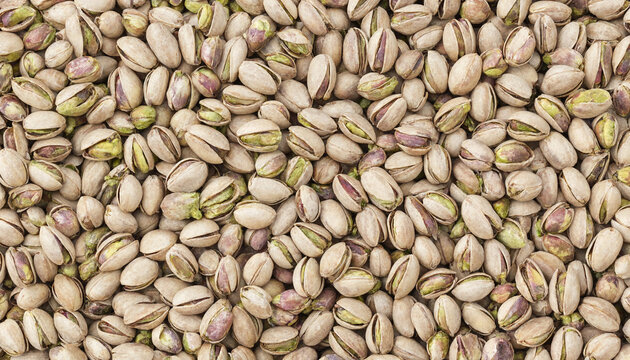 Full frame background, of raw pistachio, nuts in their, light beige shells, close up view, of a large, pile of healthy, organic snacks for, food texture