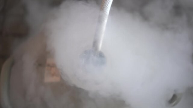 Close-up of thick white vapor cloud created by pouring liquid nitrogen.