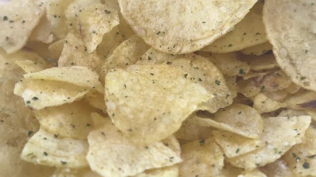 Close-up of potato chips with greens. High quality 4k footage