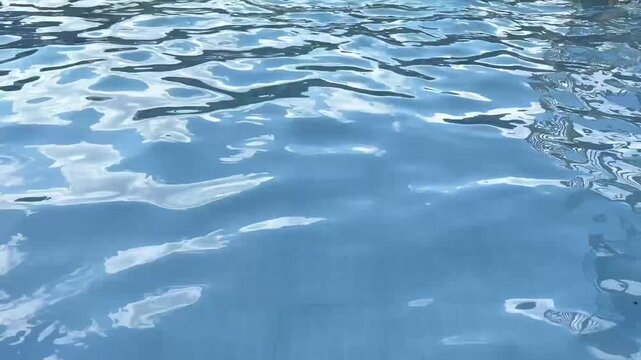 Rippled Blue Swimming Pool Water with Sunlight Reflections