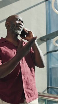 Happy, business and black man with phone call for discussion or proposal in office building. Businessman, laughing or smile with smartphone for chatting, negotiation or communication in workplace