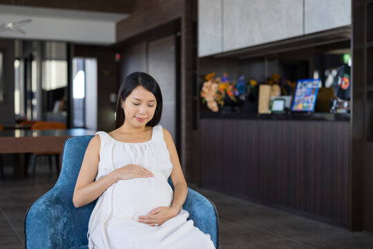 Pregnant woman resting in chair