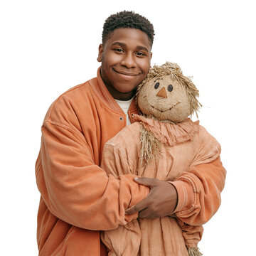 Happy Young Black Man Hugging a Straw Scarecrow Doll isolated on transparent or white background, png