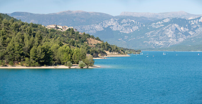 Sainte-Croix-du-Verdon, France - 07 05 2026: Panoramic view of the Lake Sainte-Croix, Sainte-Croix-du-Verdon village, hills and forests in sunny blue sky