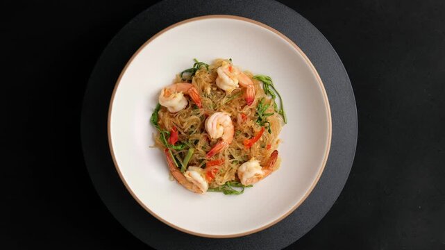 Stir Fried Glass Noodle with Water Mimosa and shrimp in white plate.Thai food.Top view.