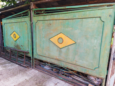 Vintage Green Metal Yard Gate with Yellow Diamond Patterned Panels