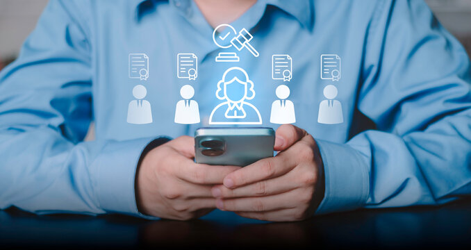 Businessman using smartphone for digital legal services. Glowing icons of lawyer, gavel, and certified documents for professional advice, compliance, and justice system