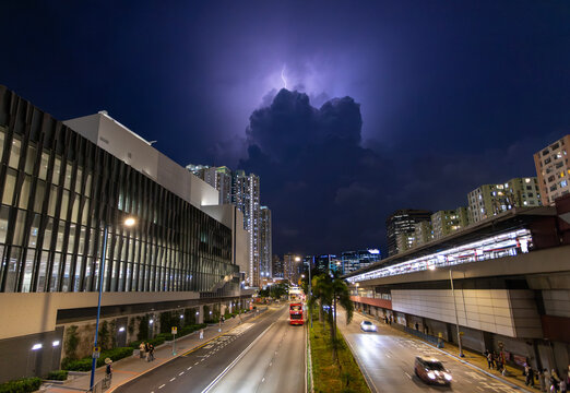 the cityscape of kowloon bay and strong lightning before the storm in hong kong