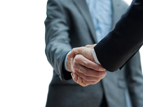 Two diverse professional business men executive leaders shaking hands at office meeting
