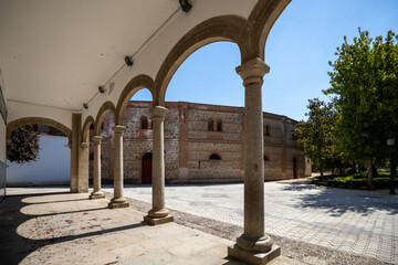 Fototapeta premium Columns at the entrance to the Basilica of Our Lady of El Prado in Talavera de la Reina, Toledo, Spain, with the bullring in the background