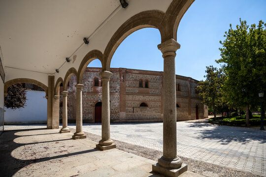 Columns at the entrance to the Basilica of Our Lady of El Prado in Talavera de la Reina, Toledo, Spain, with the bullring in the background