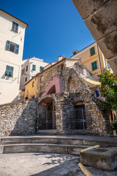 Cervo, liguria, italy. June 22, 2025. Cervo village showing stone architecture, intricate archways, and traditional buildings under a clear blue sky in liguria, italy