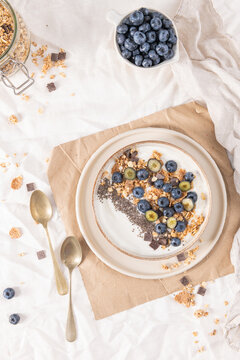 Healthy yogurt bowl with blueberries, granola, and chia seeds served in a rustic ceramic bowl for a nutritious and delicious morning meal