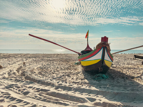Traditional Portuguese fishing boat on sandy beach
