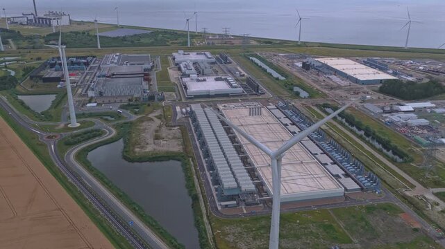 Aerial view of a hyperscale data center campus with wind turbines
