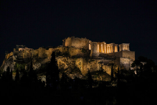The Acropolis and Parthenon illuminated at night in Athens, Greece, showcasing the grandeur of the ancient citadel above the city.